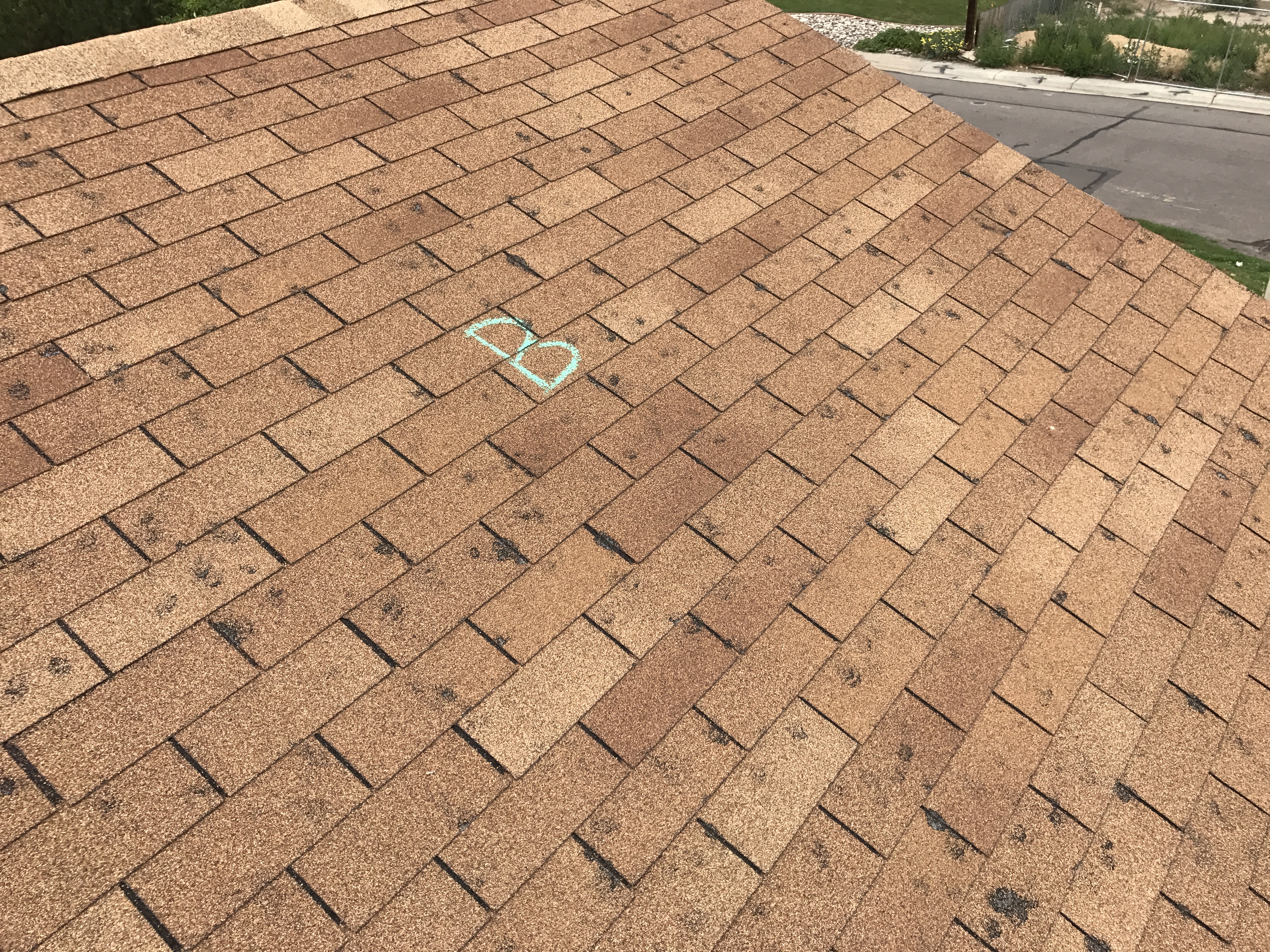 Major hail damage to 3 -tab 25 year shingles