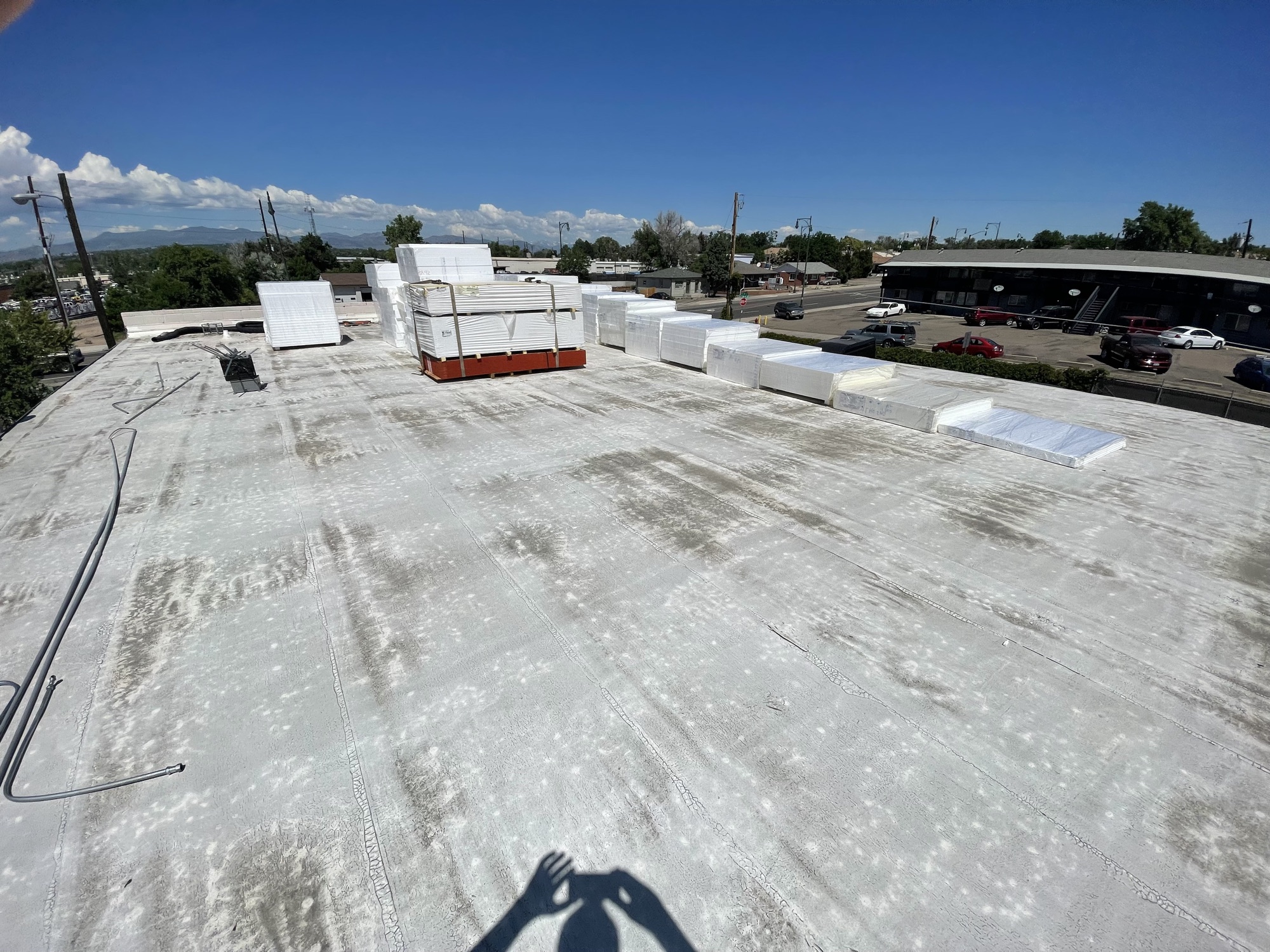 Materials for Tar and Gravel replacement in Arvada, taper system stacked on adjacent roof line